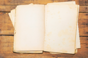 An unbound book sitting on wood panels