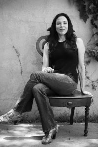 Black and white photo of Toni Ann Johnson sitting on a wooden chair