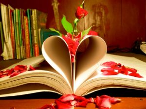 A book covered in flower petals with the pages formed into a heart