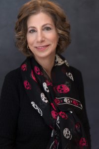 Jode Millman wearing a scarf with skulls