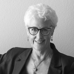 Amy S. Peele, a white woman with short white hair, glasses, and a great sense of style