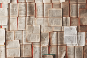 Book pages spread across a table for story bible services