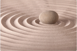 Sand ripples with a rock in the center