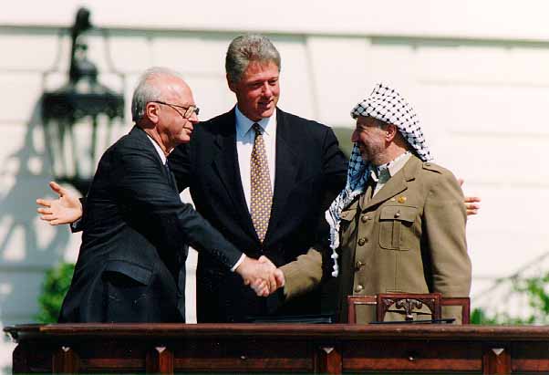  Yitzhak Rabin shakes hands with Yasser Arafatat the White House in 1993 as Bill Clinton looks on