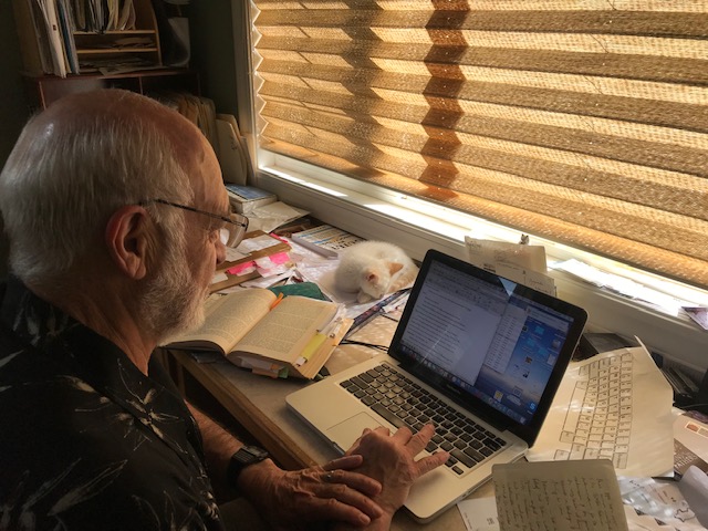 Michael J. Cooper working with his kitten in the early morning