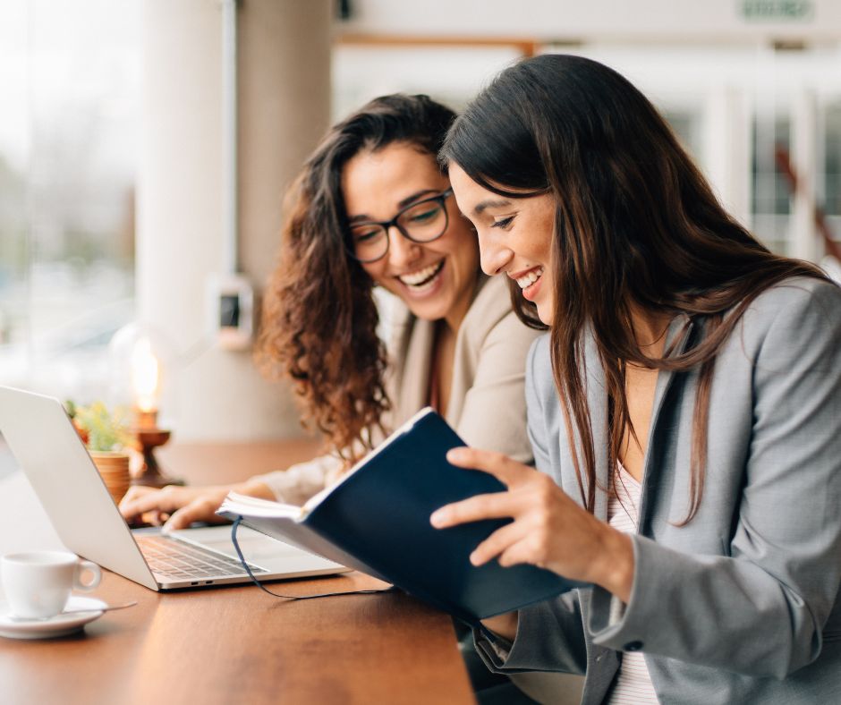 Friends, women, books, computer, smiling