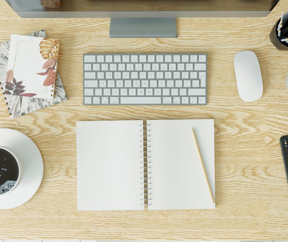 Writing space, keyboard, paper, pen, pencil, mouse, coffee, cup, journal, book