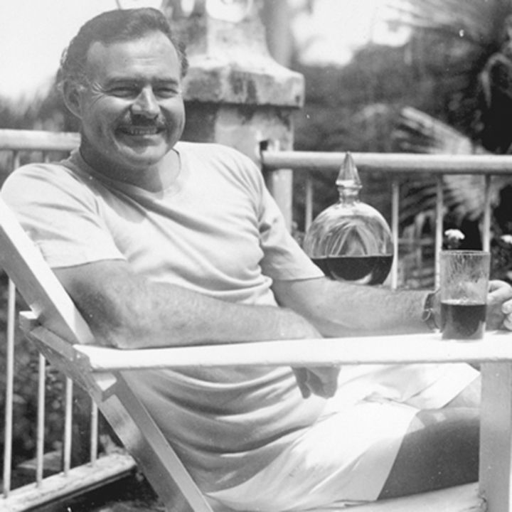 Hemingway, Patio, black and white, drink, cocktail, smiling, man, white shirt, white shorts, liquor
