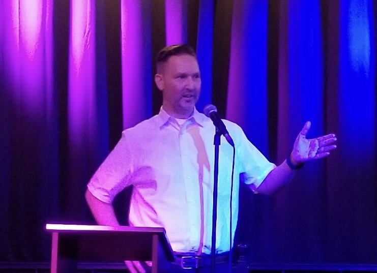 Timothy S. Johnston, Purple, Blue, microphone, man, podium, curtain