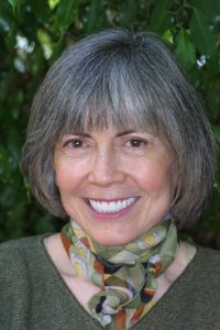 Anne Rice, woman, scarf, green, shirt, grey, hair, foliage