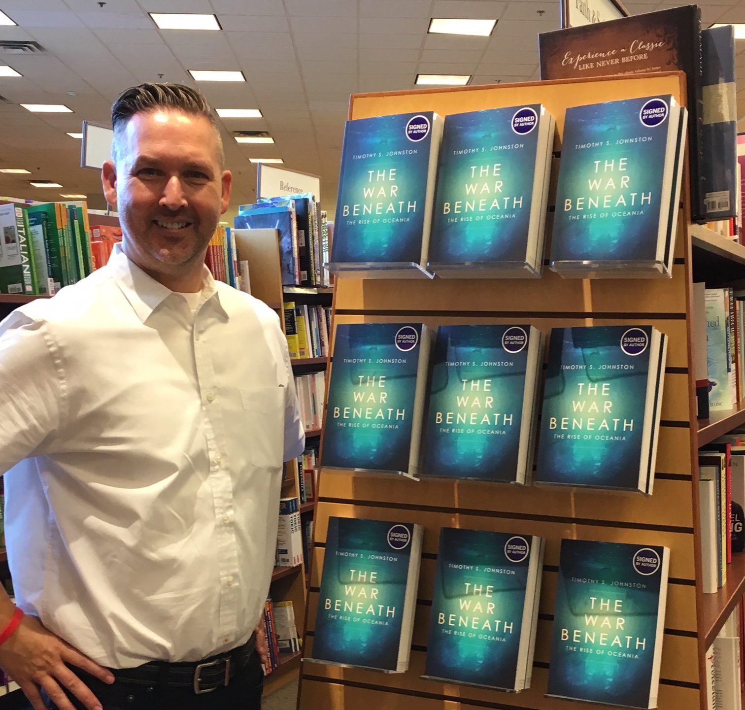 man, shadow, white shirt, books, end cap