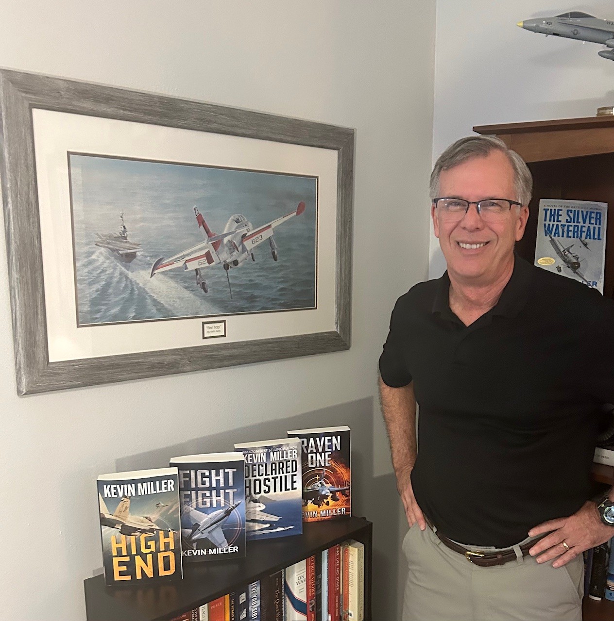 Kevin Miller, books, painting, dockers, black shirt, man