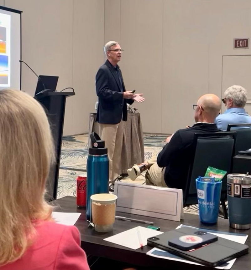 Speaker, Kevin Miller, bald head, conference room