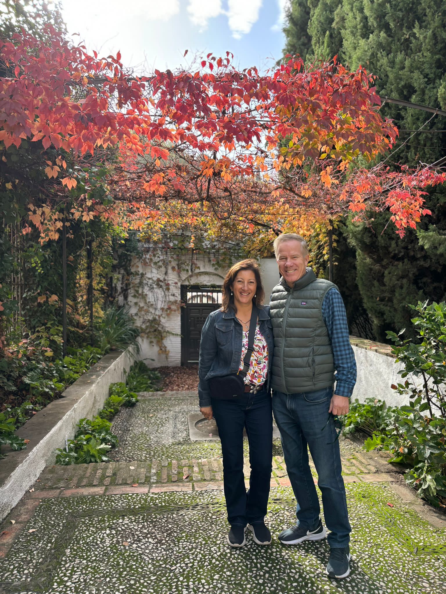 Man, woman, garden path, fall leaves
