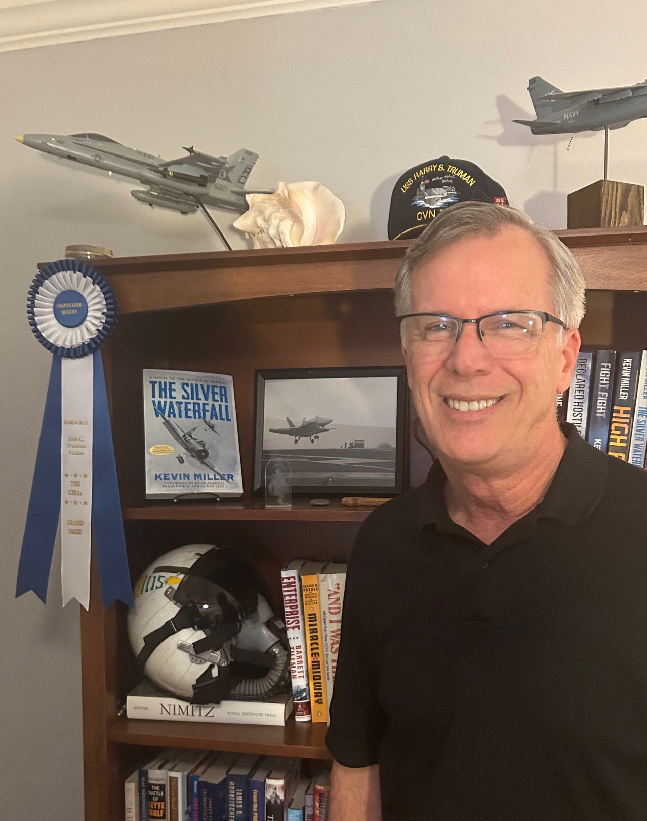 Kevin Miller, bookshelves, helmet, pictures, CIBA Grand Prize ribbon, Model jet