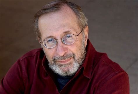John DeDakis, red sweater, glasses, author