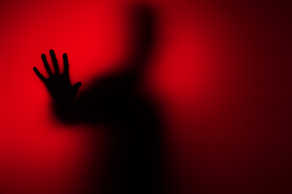 A red misted window with a dark hand for thriller horror genre