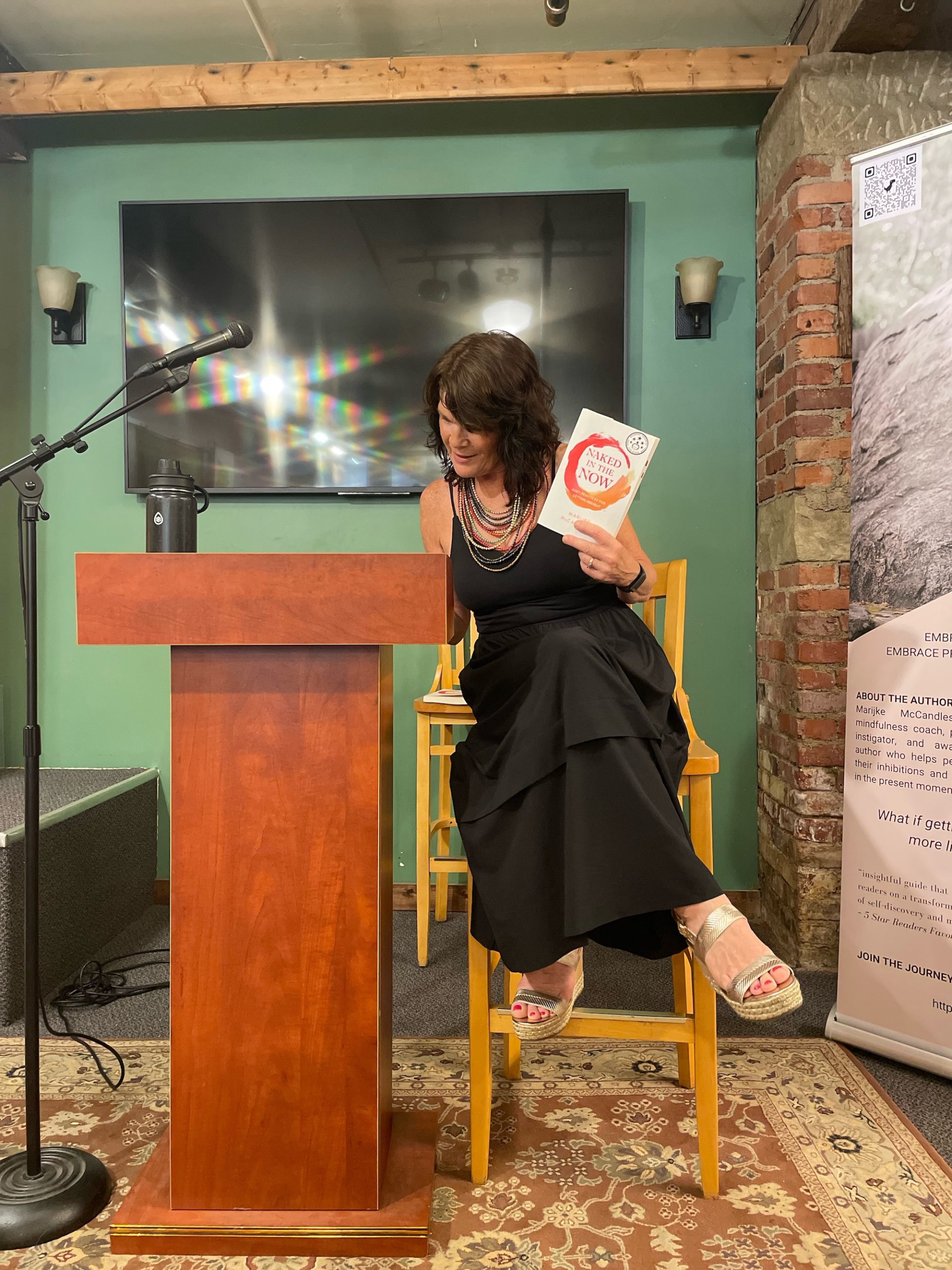 Marijke McCandless, podium, black, dress, book, mic