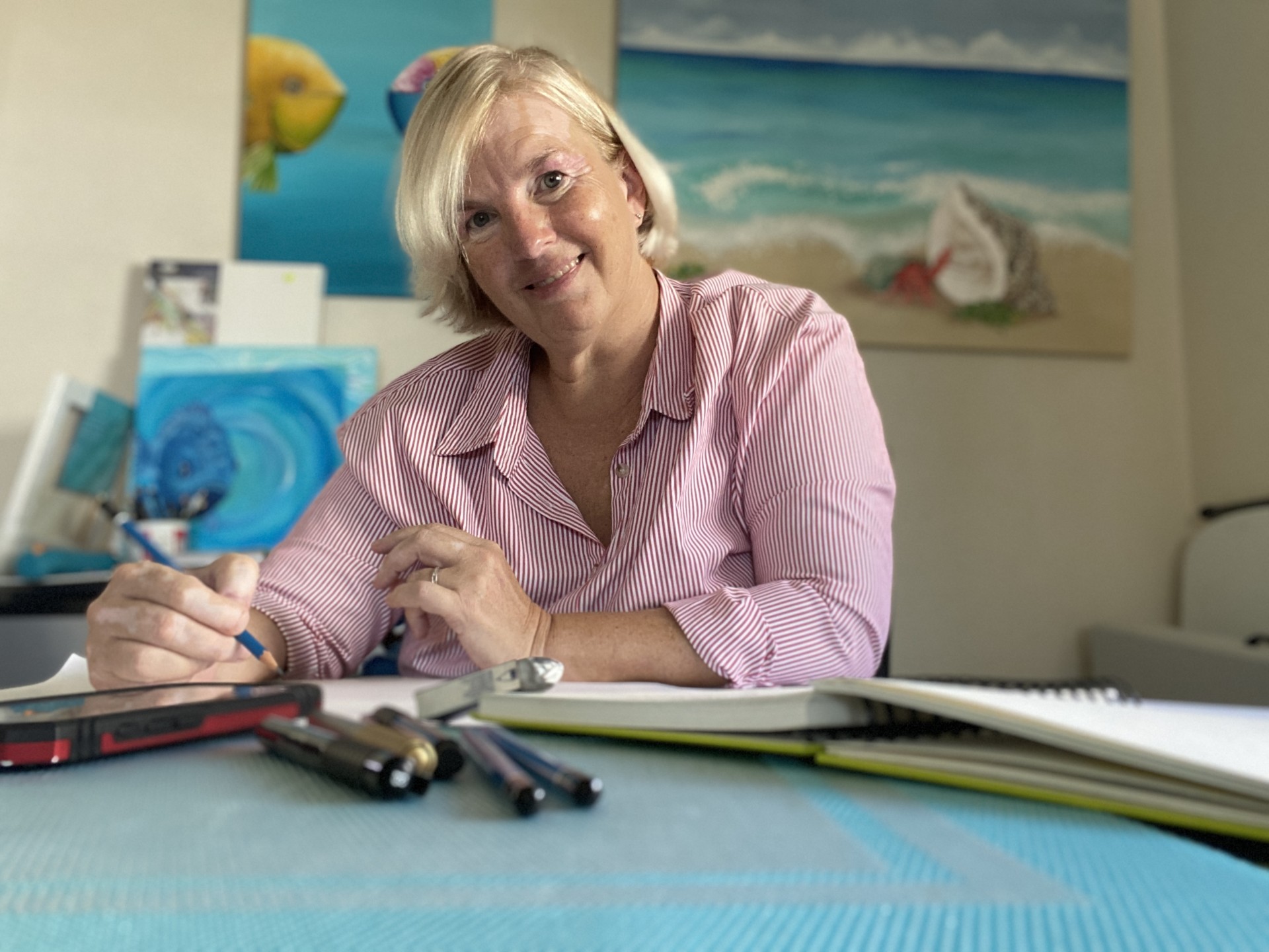 Woman, pens, posters, desk, books, blonde